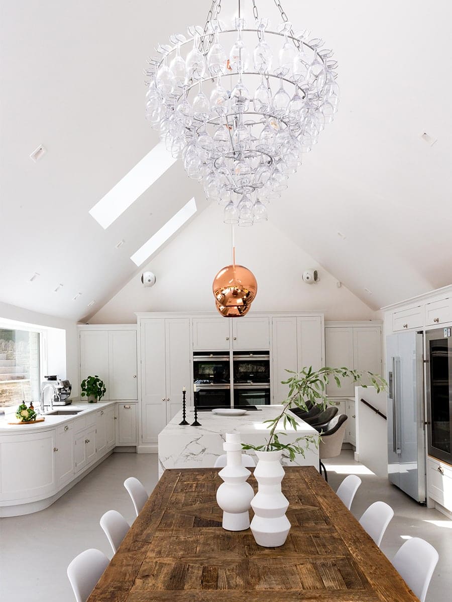 Cambray House open-plan kitchen and dining with vaulted ceiling, marble island and glass chandelier